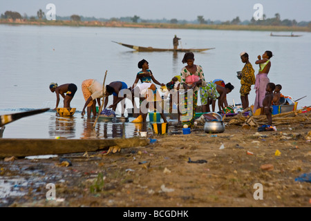 Le donne e le ragazze Wasing piatti nel fiume in Mali Segou Foto Stock