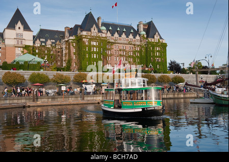 Con un taxi acqueo traghetti passeggeri intorno al Porto Interno di Victoria, B.C. La Empress Hotel può essere visto in backgroud. Foto Stock