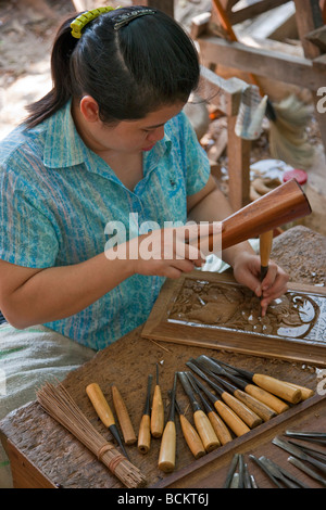 Thailandia. Una donna tailandese intagliare il legno in un workshop nei pressi di Damnern Saduak, 80 km a sud-ovest di Bangkok. Foto Stock