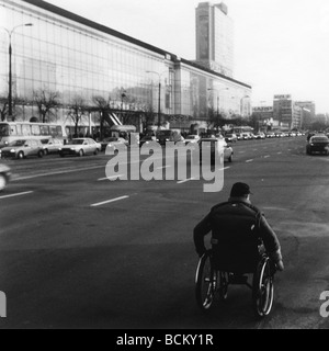 Uomo in sedia a rotelle sulla strada, b&W Foto Stock