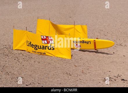 Tavola da Surf e frangivento visualizzando il logo RNLI Foto Stock