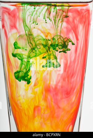 Colorati colorante alimentare gocce galleggianti in acqua per realizzare modelli astratti Foto Stock