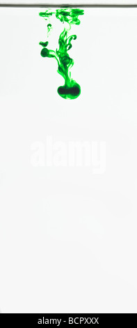 Colorati colorante alimentare gocce galleggianti in acqua per realizzare modelli astratti Foto Stock