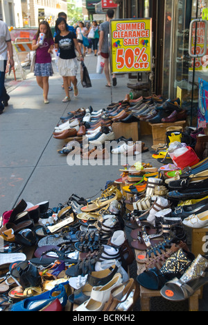 Agli acquirenti di passare una scarpa store su Fulton Street in Lower Manhattan a New York Foto Stock