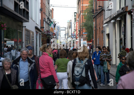 I turisti nelle strette strade della zona di Temple Bar a Dublino Repubblica di Irlanda Foto Stock