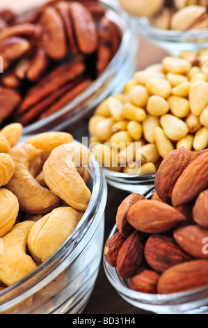 Anacardi Mandorle e Pistacchi Pinoli in ciotole in vetro Foto Stock