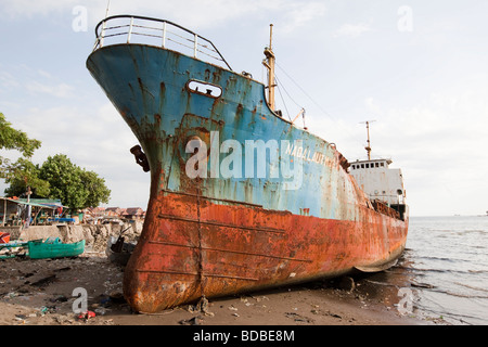 Indonesia Sulawesi Makassar lungomare nave mercantile arenata sulla spiaggia Foto Stock