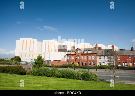 BAE Systems edifici adombrando vecchie case a schiera a Barrow in Furness Cumbrias REGNO UNITO Foto Stock