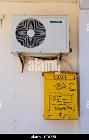 Casella postale sotto unità aria condizionata su edificio nel villaggio rurale di Agios Nikolaos sull'isola greca di Cefalonia Grecia GR Foto Stock