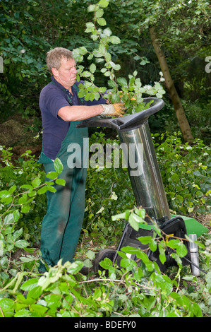 Di mezza età lavoratore forestale con trinciatrice Foto Stock