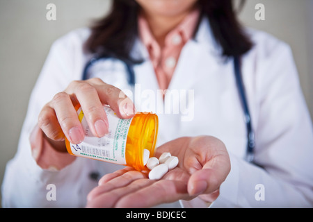 Medico tenendo una bottiglia di pillole Foto Stock