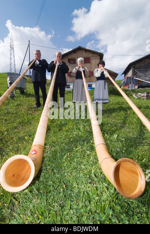 Alphorn giocatori nel cantone svizzero dei Grigioni. Foto Stock