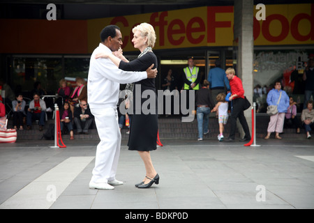 Glamorous razza mista coppia di anziani ballare nel foyer presso la Royal Festival Hall a South Bank di Londra Foto Stock