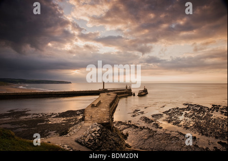 Tramonto su Whitby Piers come visto da Hagerlythe Foto Stock