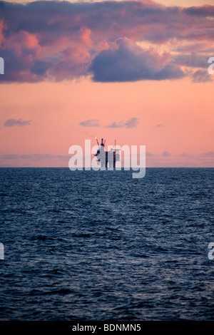 Sun impostata a oriente brae oil rig Foto Stock