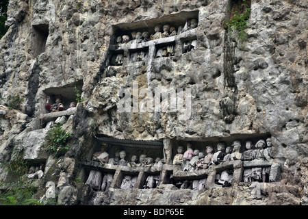 Indonesia Sulawesi, Tana Toraja area, Suaya village, re della pietra memorial tombe con legno tau tau effigi dei morti. Foto Stock