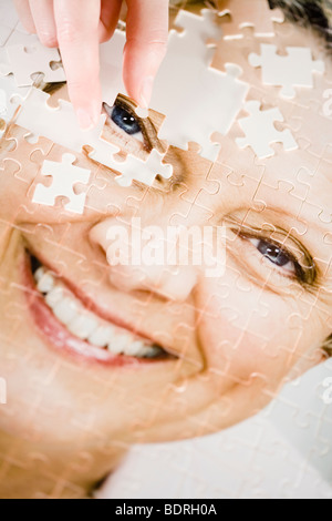 Un puzzle con l'immagine di una donna. Foto Stock