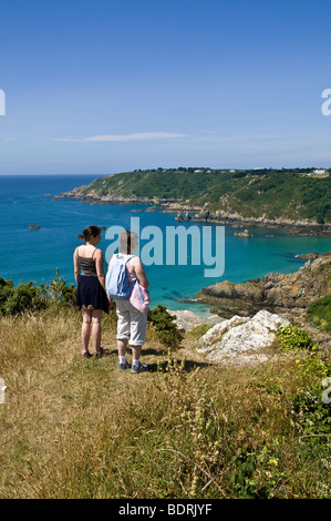 Dh Moulin Huet Bay St Martin Guernsey Donna e bambina cercando in vista della baia e della costa meridionale di due persone Foto Stock