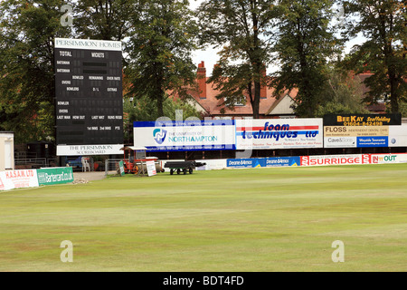 Un quadro di valutazione di cricket con striscioni pubblicitari Foto Stock