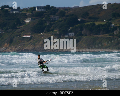 Kitesurfer accelerando attraverso le onde a Les Pieux, Normandia, Francia Foto Stock