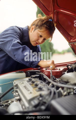 Latina tecnico che lavora su auto sistema elettrico Foto Stock