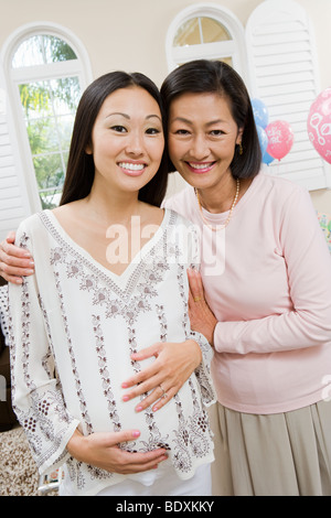 Incinta donna asiatica con la madre a un bambino, doccia Foto Stock