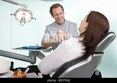 Un dentista in chirurgia con un paziente Foto Stock