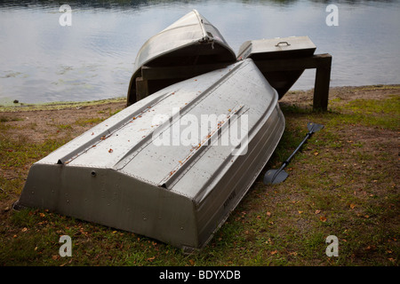 Imbarcazioni a remi sulla riva di un lago Foto Stock