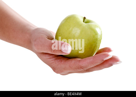 Mano che tiene una mela verde Foto Stock