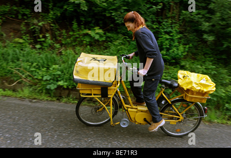 Supporto per posta Annerose Schulze la guida della sua azienda bicicletta nel suo distretto per la Deutsche Post AG tedesca in Mail Sonnenberg in Foto Stock