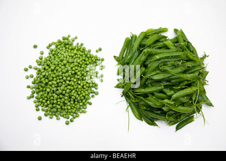 Un mucchio di piselli sgranati e una pila di custodie vuote Foto Stock