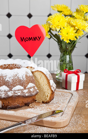 Una torta di Bundt, fiori e un regalo per la Festa della mamma Foto Stock