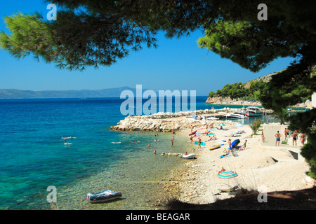 Turisti che si godono il loro tempo a una spiaggia nel villaggio di Zivogosce, Croazia Foto Stock