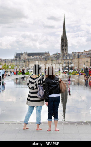 Miror d'eau due giovani donne st michel chiesa place de la Bourse Bordeaux Francia Foto Stock