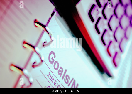 Close-up di un calcolatore con un notebook a spirale Foto Stock