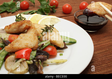 Pangasius filet su un letto di verdure asiatica dolce con salsa di soia Foto Stock