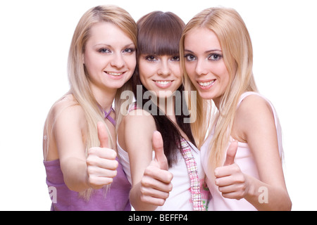 Le tre ragazze insieme dando pollice in su su sfondo bianco Foto Stock