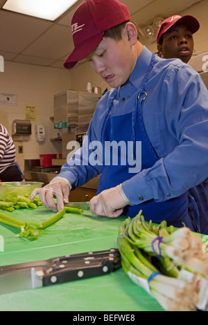 Evolutivamente gli studenti disabili nella preparazione alimentare classe alla scuola pubblica Foto Stock