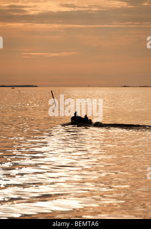 Pescatori che si dirigano in mare in un piccolo motoscafo / skiff nel Mar Baltico , Golfo di Bothnia , Finlandia Foto Stock