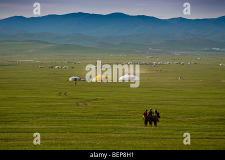 Il mongolo Kids cavalli casa su un pomeriggio soleggiato sulla steppa Foto Stock