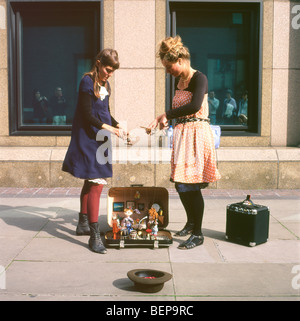 Le puppeteers femminili intrattengono le persone con la loro rock band puppet Mostra sulla strada a Londra Inghilterra Regno Unito KATHY DEWITT Foto Stock