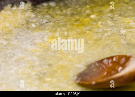 Un trito di cipolle fritte in padella Foto Stock