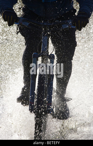 In mountain bike attraverso l'acqua. Foto Stock