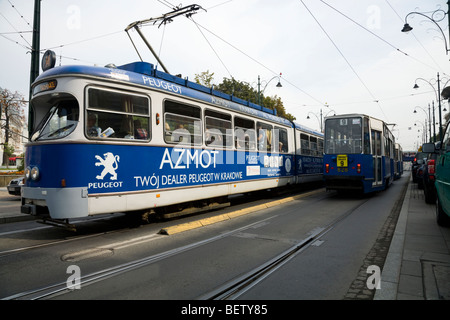 Moderne camere doppie - lunghezza tram accanto al vecchio stile di tram vicino alla piazza principale del mercato / Markt Square. Cracovia. La Polonia. Foto Stock