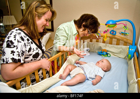 Servizio baby il suo 6-mese-vecchio nipote, una nonna in Laguna Niguel, California, interagisce con il bambino come un relativo orologi Foto Stock