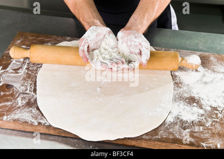 Chef's mani coperte con farina Foto Stock