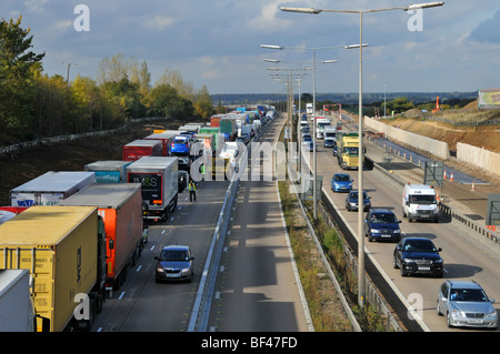 La polizia distanti cercando di girare intorno paralizzata traffico su autostrada M25, lavori stradali sezione dopo la chiusura a causa di un incidente Foto Stock