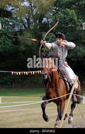 Un partecipante spara suo freccia al bersaglio a al galoppo, aprire Eocha campionato europeo 09, montato tiro con l'arco, con la steppa Foto Stock