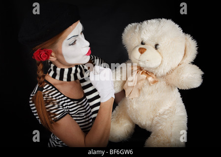 Ritratto di una giovane donna vestito come un mime isolate su sfondo nero Foto Stock