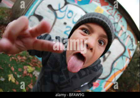 Ragazzo giovane dando atteggiamento da muro di graffiti Foto Stock